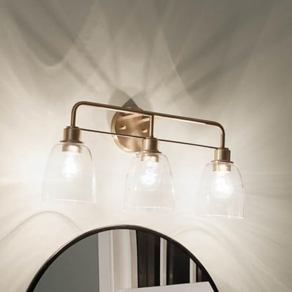 Kichler Meller 24.25" 3-Light Bathroom Vanity Light Fixture with Clear Glass Shades in Champagne Bronze for Mirror or Powder Room (24.25" W x 11.25" H x 7" D) 55102CPZ - color: Champagne Bronze, style: 3 Light